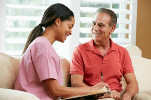A man talking to a dental assistant