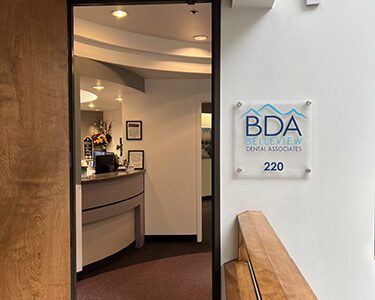 Entrance to Belleview Dental Associates office, suite 220, featuring the BDA sign and reception desk inside.