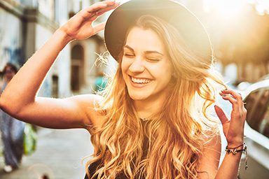 Portrait of young woman with hat smiling